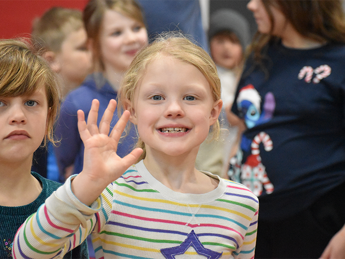 student waving